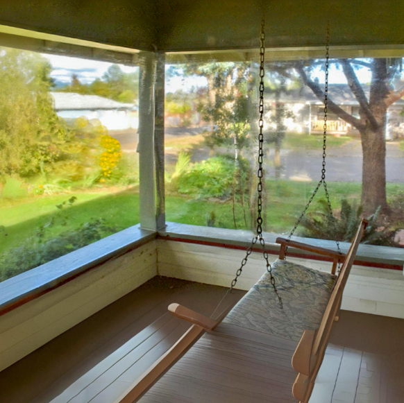 Weather Protected Patio Front Porch using Calendared Vinyl Sheeting installed over the open areas to Keep out the elements and preserve the view.